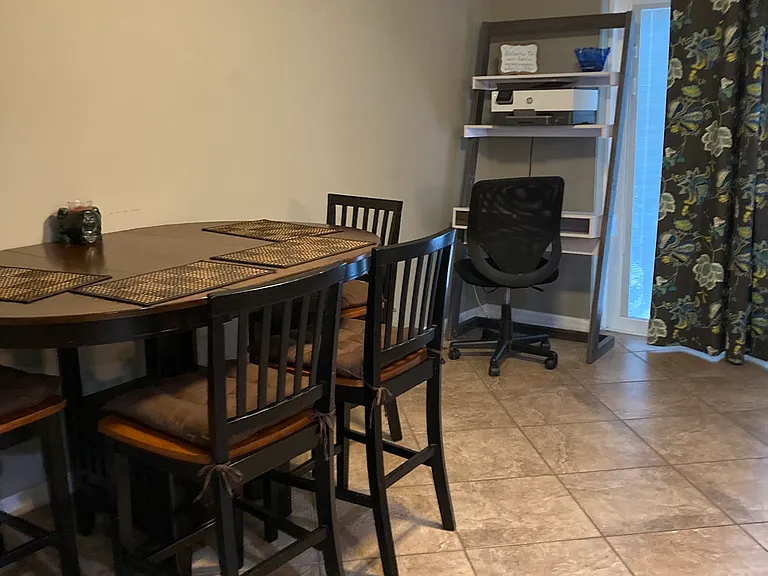 Dining room area facing back porch screen door