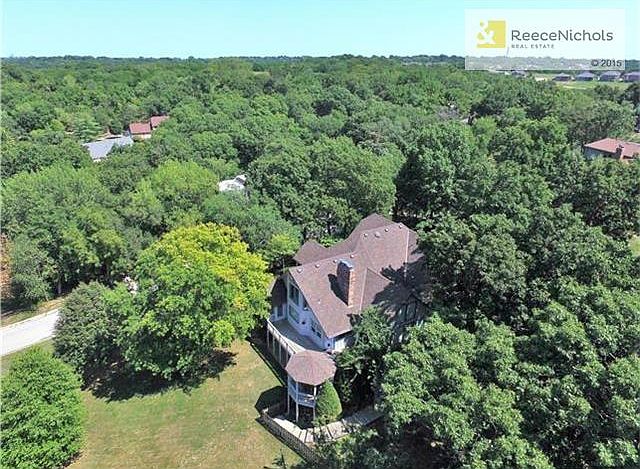 Beautiful hill top setting among the trees with expansive views on over an acre. This property comprises of two lots!
