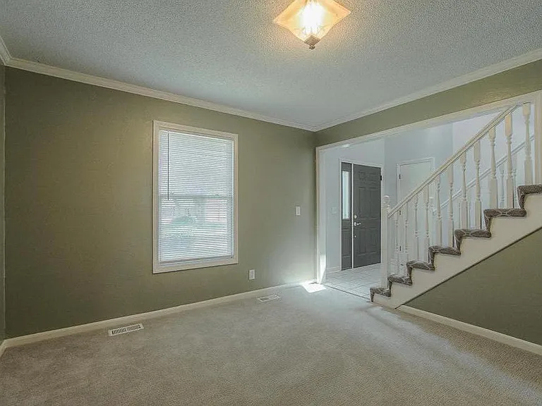 The formal dining room is steps from the kitchen and could easily be an office or playroom.