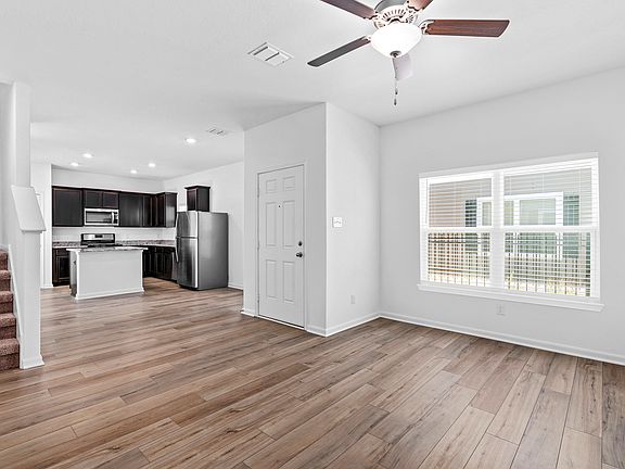 Open layout with a large living room leading into the upgraded kitchen.