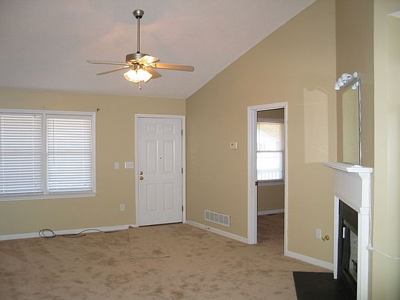 Large bright open living room w/ beautiful fireplace