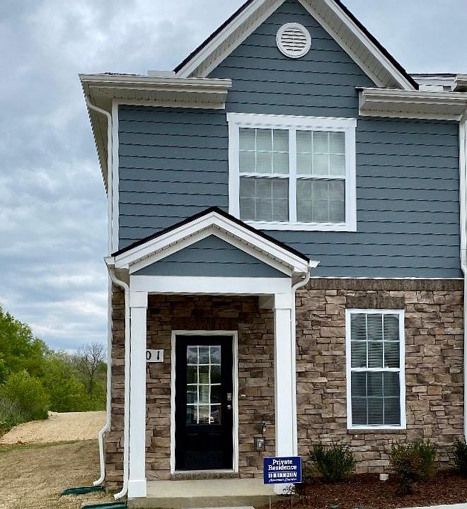 CORNER UNIT. LOADS OF LIGHT. LOOKING AT POOL HOUSE. 2 DESIGNATED PARKING PLACES IN FRONT OF TOWNHOME.