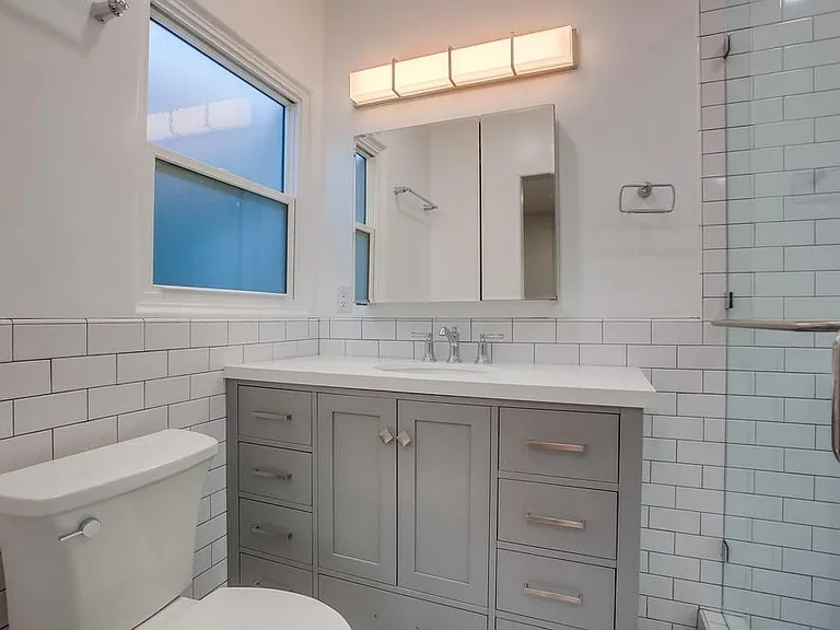 Brand new primary bathroom with subway tile and large
 walk-in shower.
