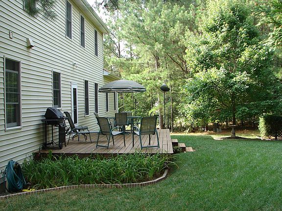 Back of house with deck and yard
