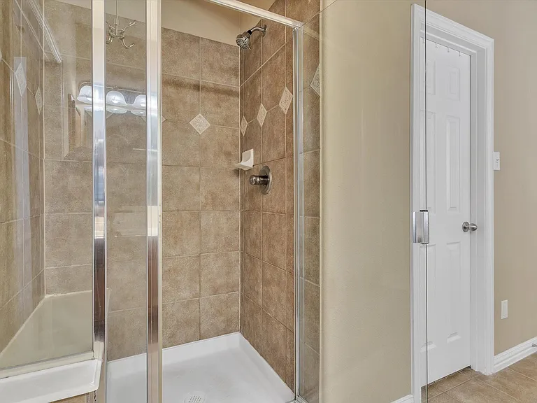 Primary shower & door to the right is the large walk-in closet. - UPDATED SHOWER