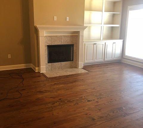 Gas log Fireplace and built in shelves with storage cabinets