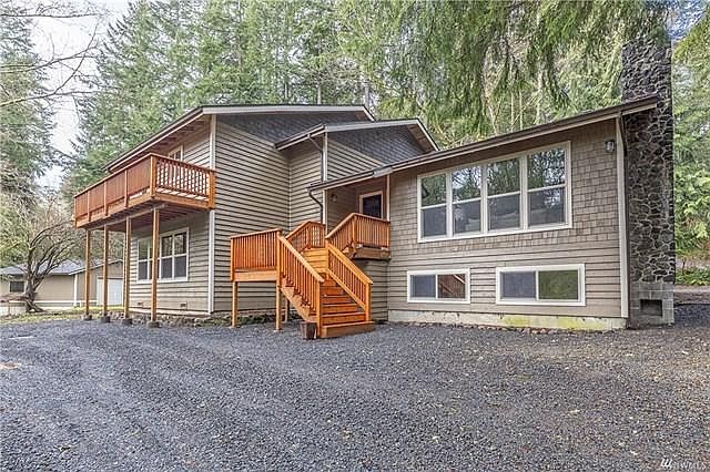 Front of house and large deck of master bedroom