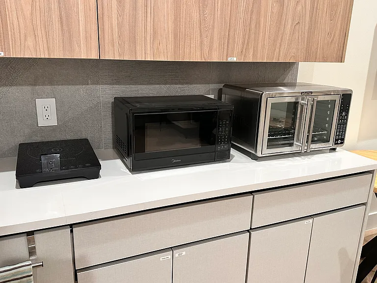 Large oven, microwave and induction cooktop.