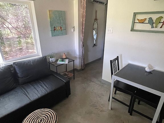 Dining table with sofa. Entrance to bedroom.