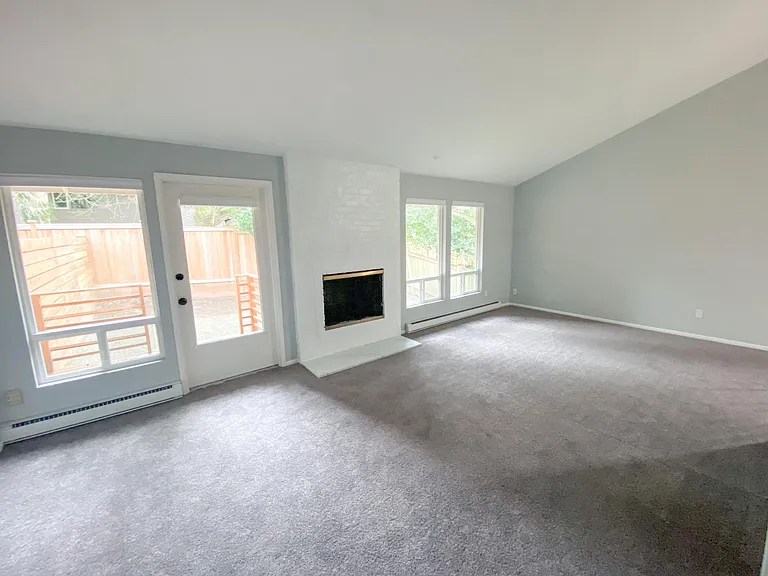 living room- includes wood burning fireplace and an exterior door to backyard
New Carpet!