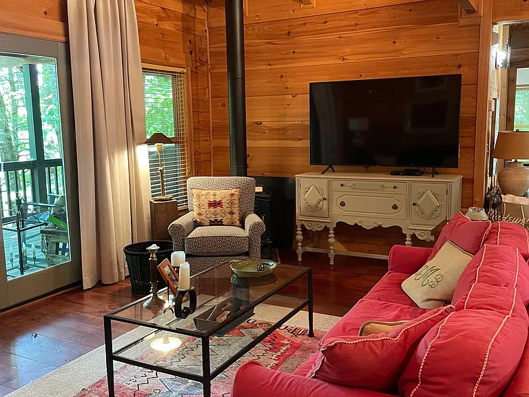 great room with large screen TV, french doors open to deck