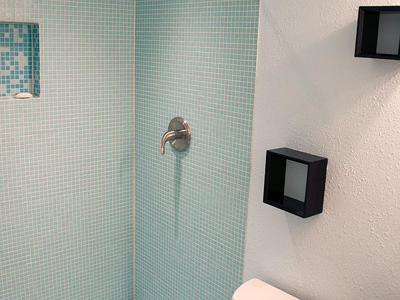 Fully remodeled bathroom with glass mosaic walk-in shower