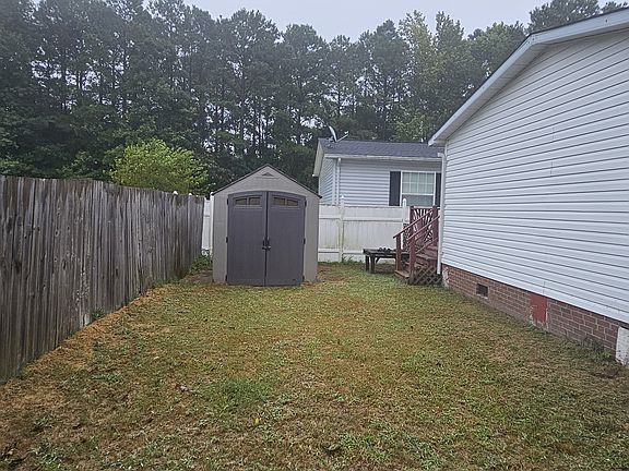Fenced yard with storage shed