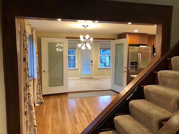 Looking from Family/Living Room to Dining Room/Kitchen (and Sunroom beyond)