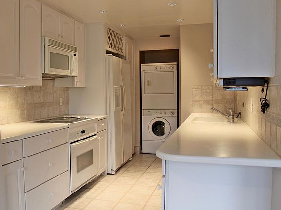 Spacious galley kitchen with real corian countertops & in un