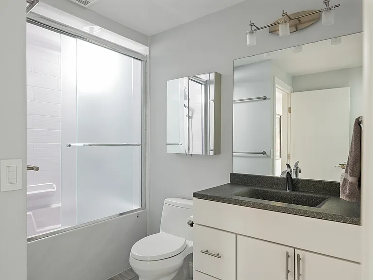 the second floor bathroom with the adjacent laundry room
