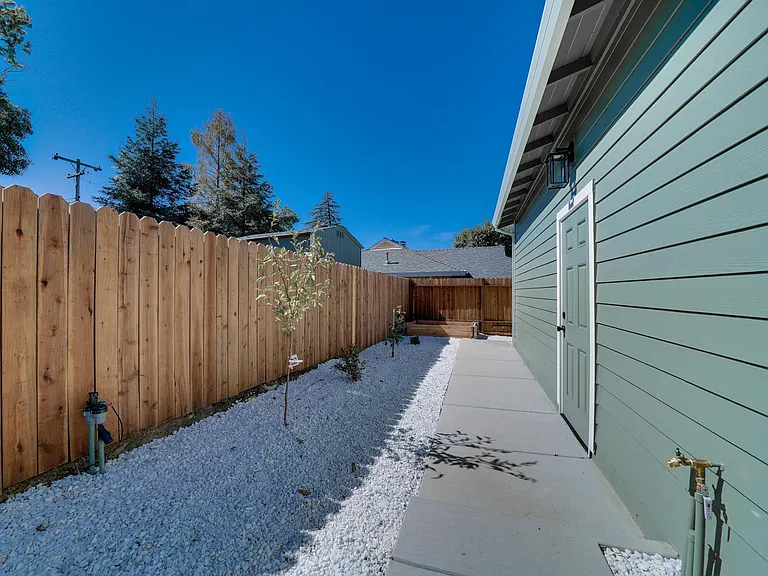 Irrigation setup to water new shrubs/tress. (2 fruit trees and a garden box!). Backyard entrance to garage in frame.