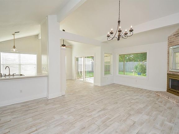 Open concept floor plan with family/kitchen/breakfast areas all open to each other. Wood look tile flooring, updated lighting and high ceilings.