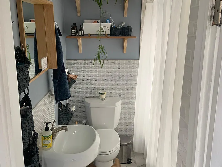 Bathroom with storage and shower/bathtub.