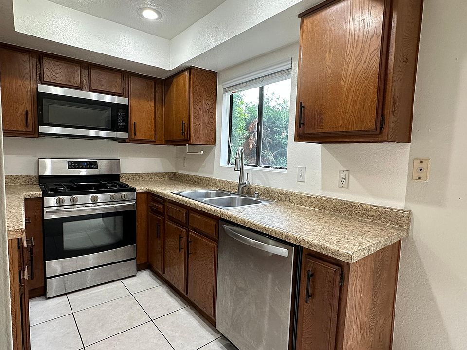 Kitchen with microwave over range and dishwasher.