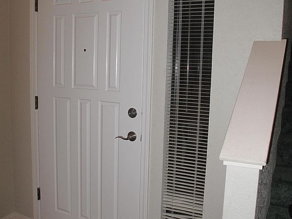 Entry of home with partial shot of stairs.