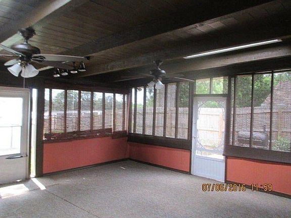 screened porch w/ ceiling fans, dart board and skylights
