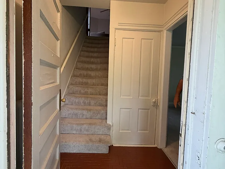 Front door coat closet and the stairs to the 2nd floor.