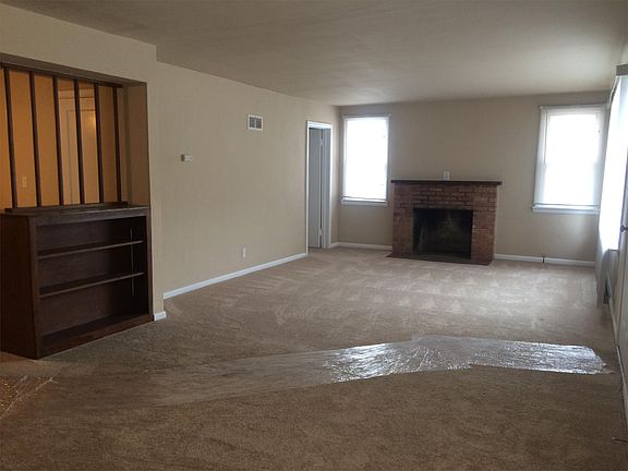 Large open living room with wood burning fireplace