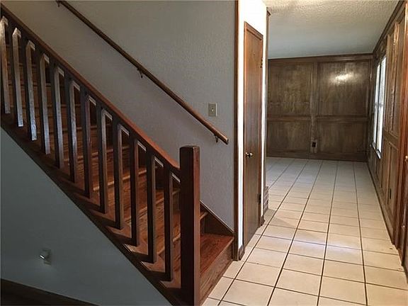 Wood staircase divides 2 living areas