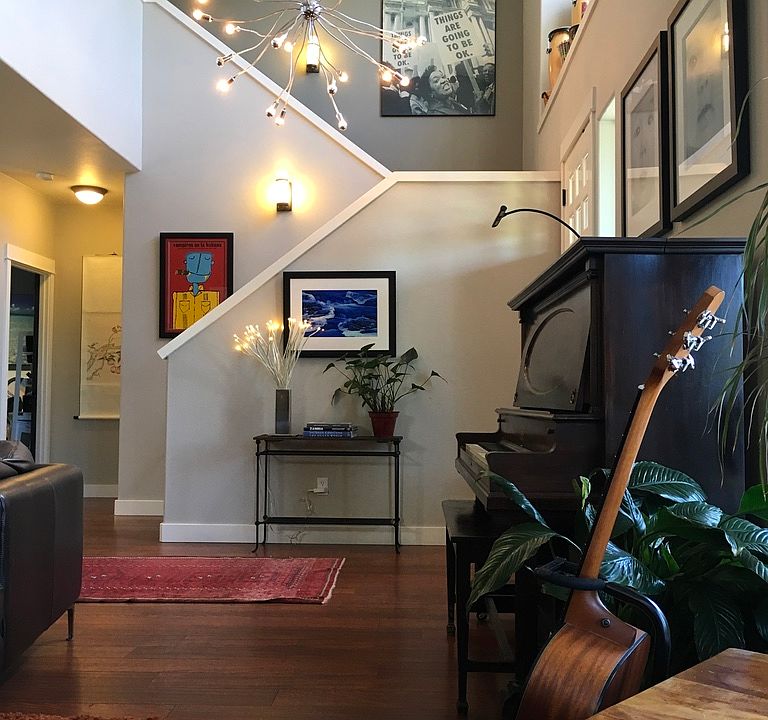 Open, 2 story foyer, loads of lights. Looking from the living room looking into foyer and stairs to second floor.