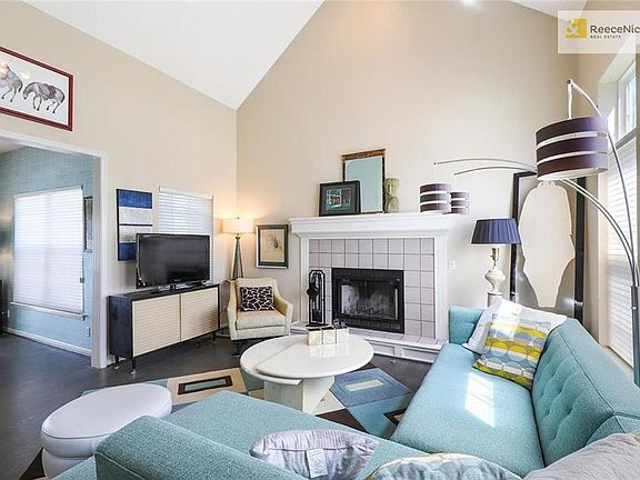 Enter into the living room with hardwood floors, vaulted ceilings, and cozy wood-burning fireplace with gas starter. Tons of natural light throughout this home!