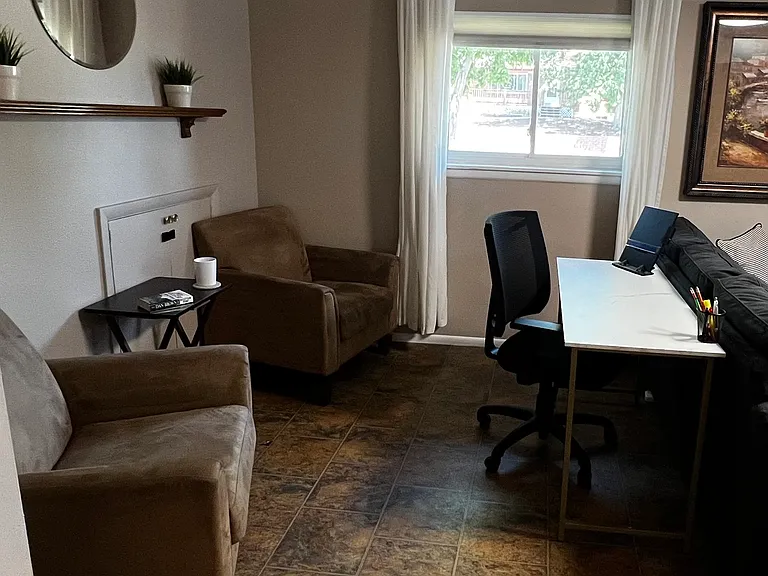 Dedicated workspace with a cozy reading nook, perfect for remote work, study, or quiet downtime.