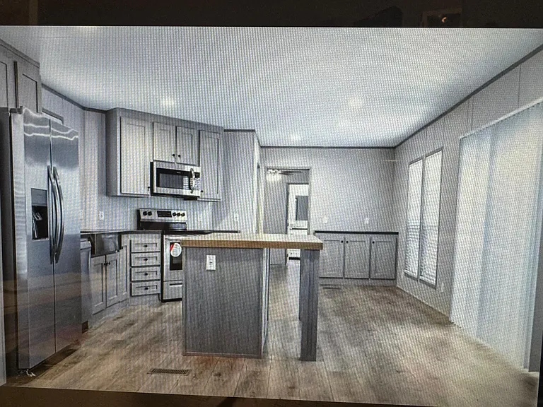 New appliances, refrigerator w/icemaker, storage under bar facing the French doors out to decking