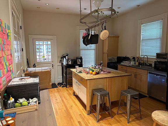 Kitchen, with table, chairs and door to back deck. Dishwasher, disposal, microwave.