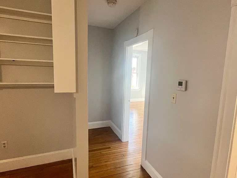 Hallway with bathroom the first right and bedroom the second right