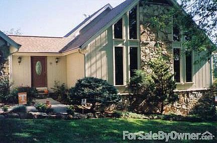 Front View
						:
						Stone, wood, vinyl. Two car garage to left of view. Beautiful shrubs & plants.