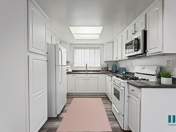 Full-Size Kitchen with Refrigerator, Stove, Dishwasher, and Microwave Oven