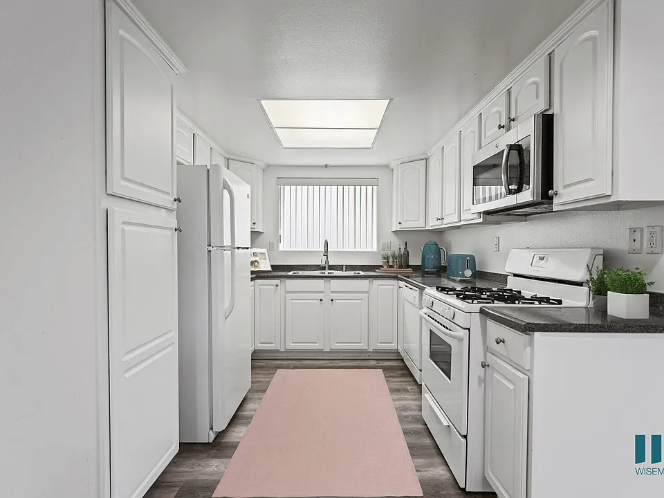 Full-Size Kitchen with Refrigerator, Stove, Dishwasher, and Microwave Oven