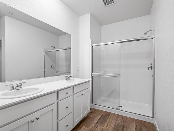 Inside the en-suite master bathroom, you ll find a step in shower and a large vanity!