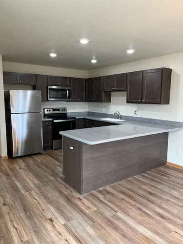 spacious kitchen featuring corrian counter tops, breakfast bar , dining area and stainless appliances - 8476 Rivers Bend Dr