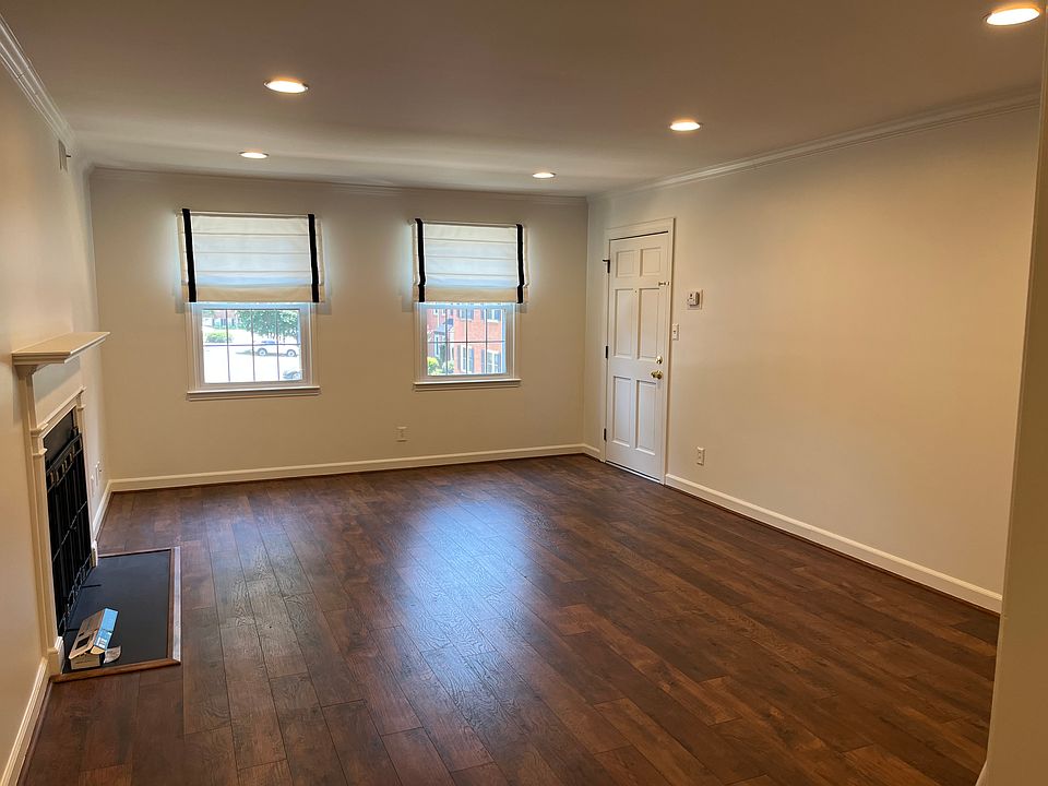 Living Room with lot's of natural light, crown molding, fireplace is decorative/not functional