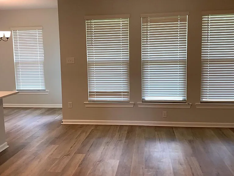 Living room with windows looking out to backyard and porch