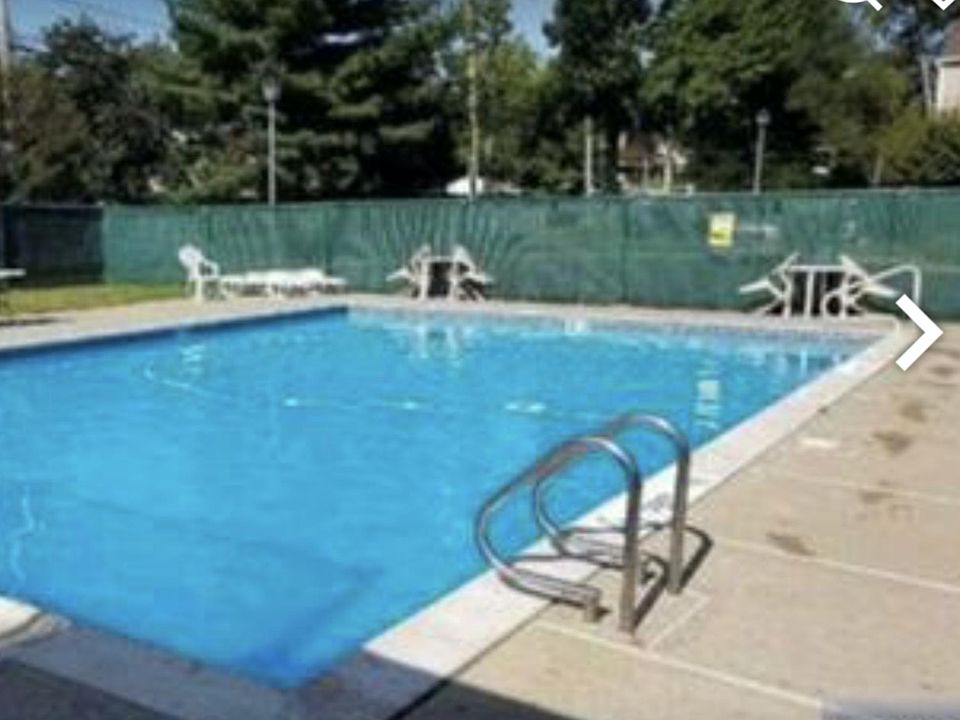 Balcony overlooks outdoor pool.