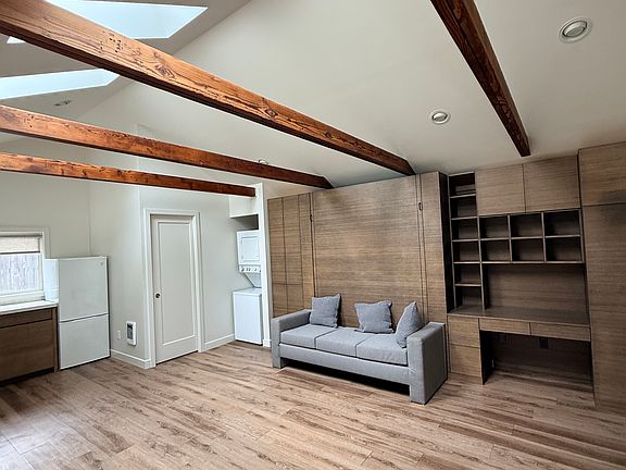 Murphy bed and office. Stacked washer dryer in corner.