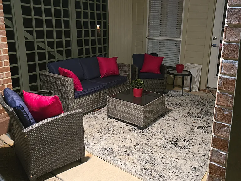 Outdoor patio area with included mounted TV