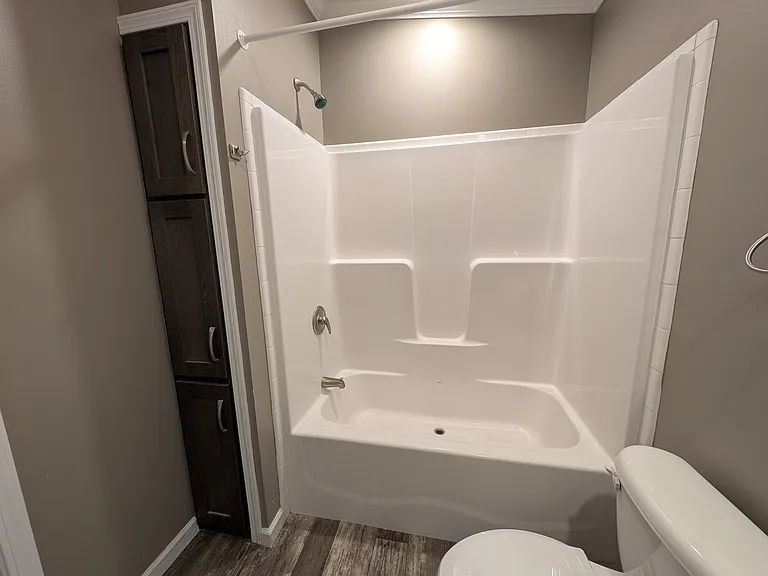 Bathtub with extra linen storage to left