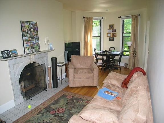 Living room with bow front and ornamental fireplace