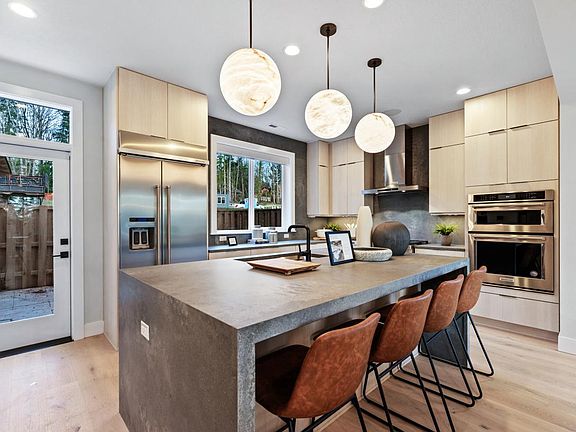 Kitchen with large center island and access to rear yard