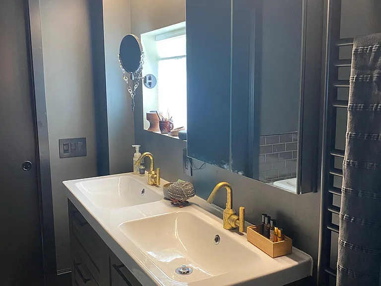 Double sinks, vanity lighting, towel warmer.