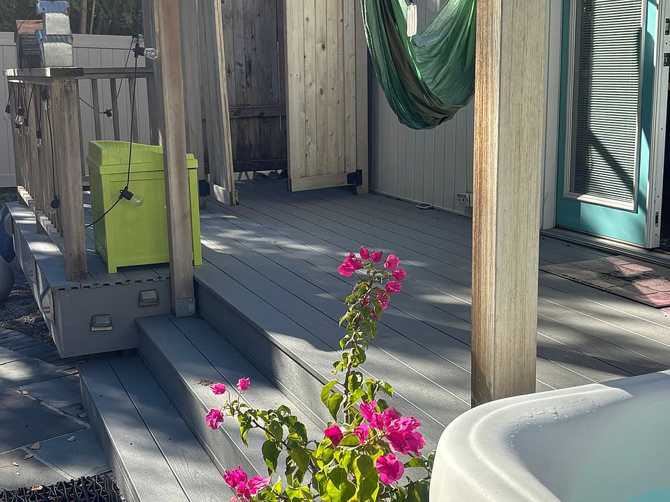 Backyard deck, hot tub and outdoor shower.